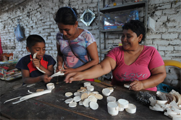 Women and child, making candy, Zaña, Peru